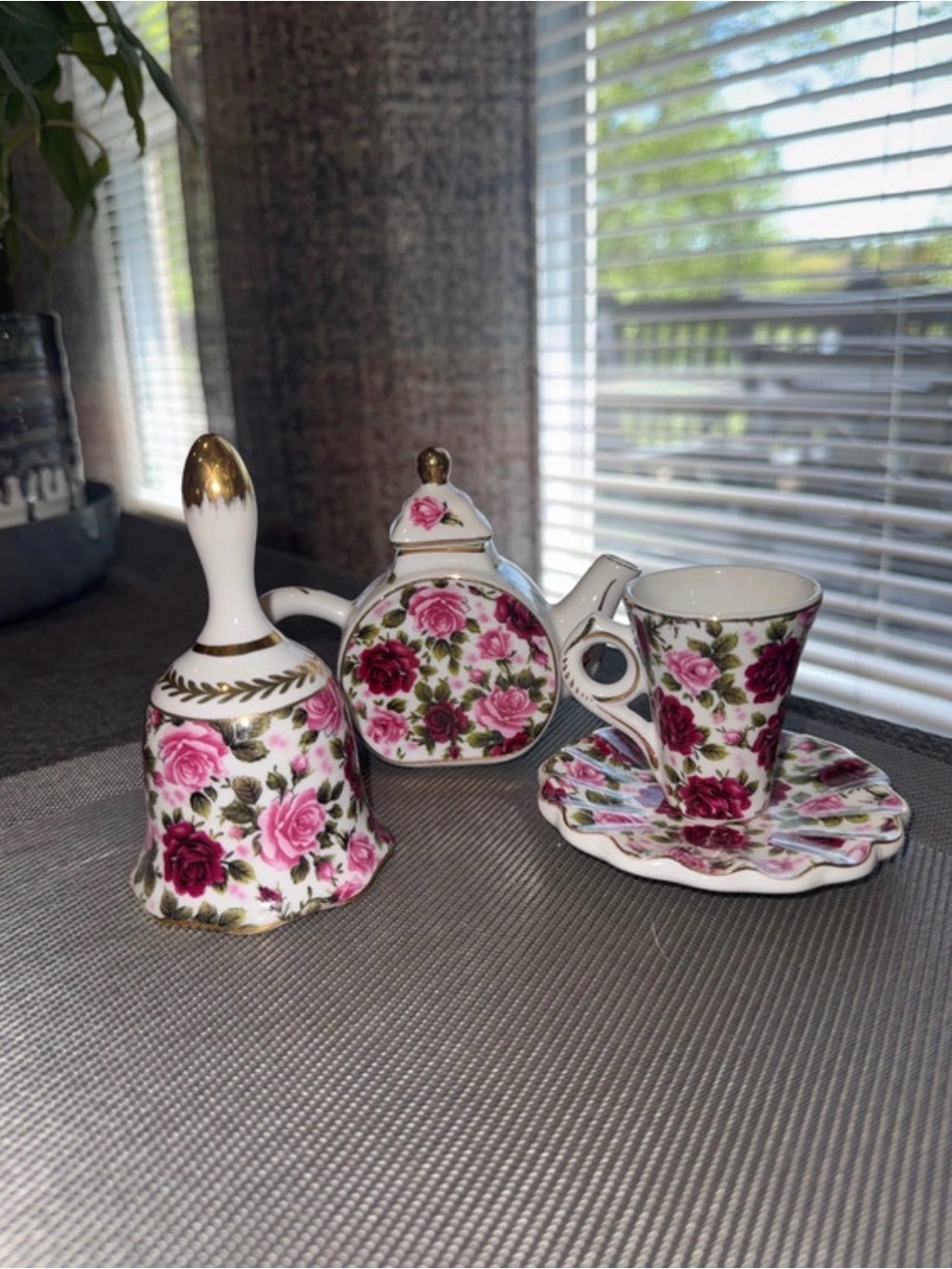 Miniature porcelain tea set features a floral rose chintz pattern